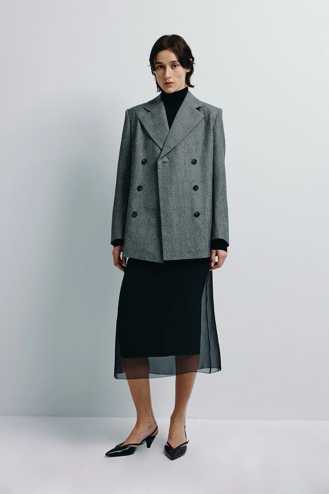 Emery Plaid Blazer in grey wool, double-breasted with structured shoulders, paired with black skirt.