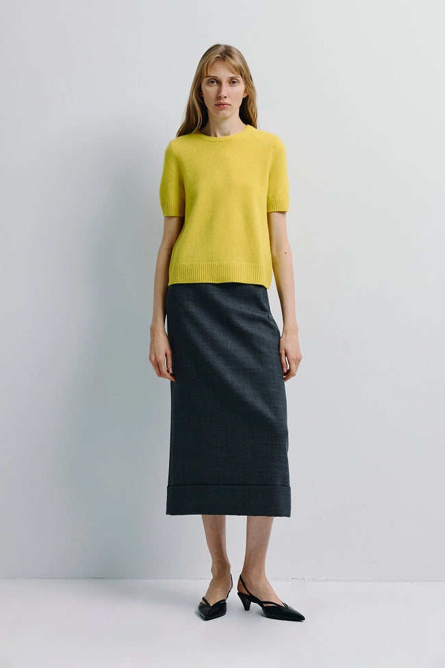 Leta Crewneck Sweater in yellow, paired with dark grey skirt and black shoes