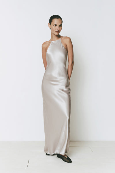 Floor-length satin dress, high neck and open back, perfect for special events.