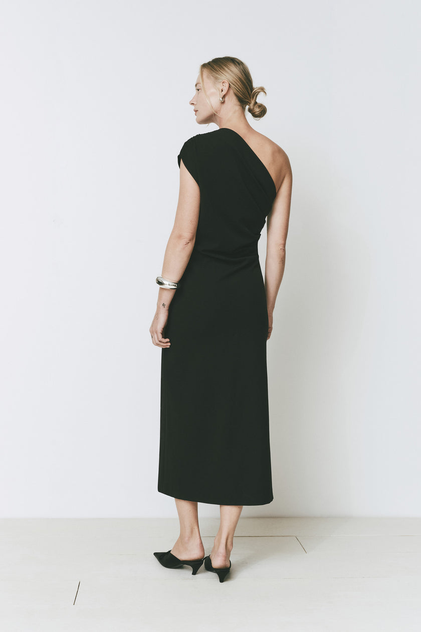 Palais Dress in black, midi dress featuring one-shoulder design and elegant draping detail