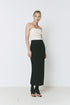 Ruesophie Figaro Skirt - Black midi skirt with a slim fit, paired with a cream top and sandals for a stylish outfit.