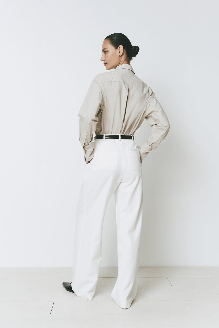 Librarie Button Down Shirt in neutral tone, paired with white wide-leg pants. Minimalist outfit.