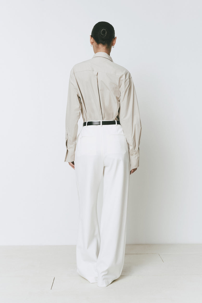 Librarie Button Down Shirt, neutral top with white wide-leg pants and black belt. Modern minimalist outfit.