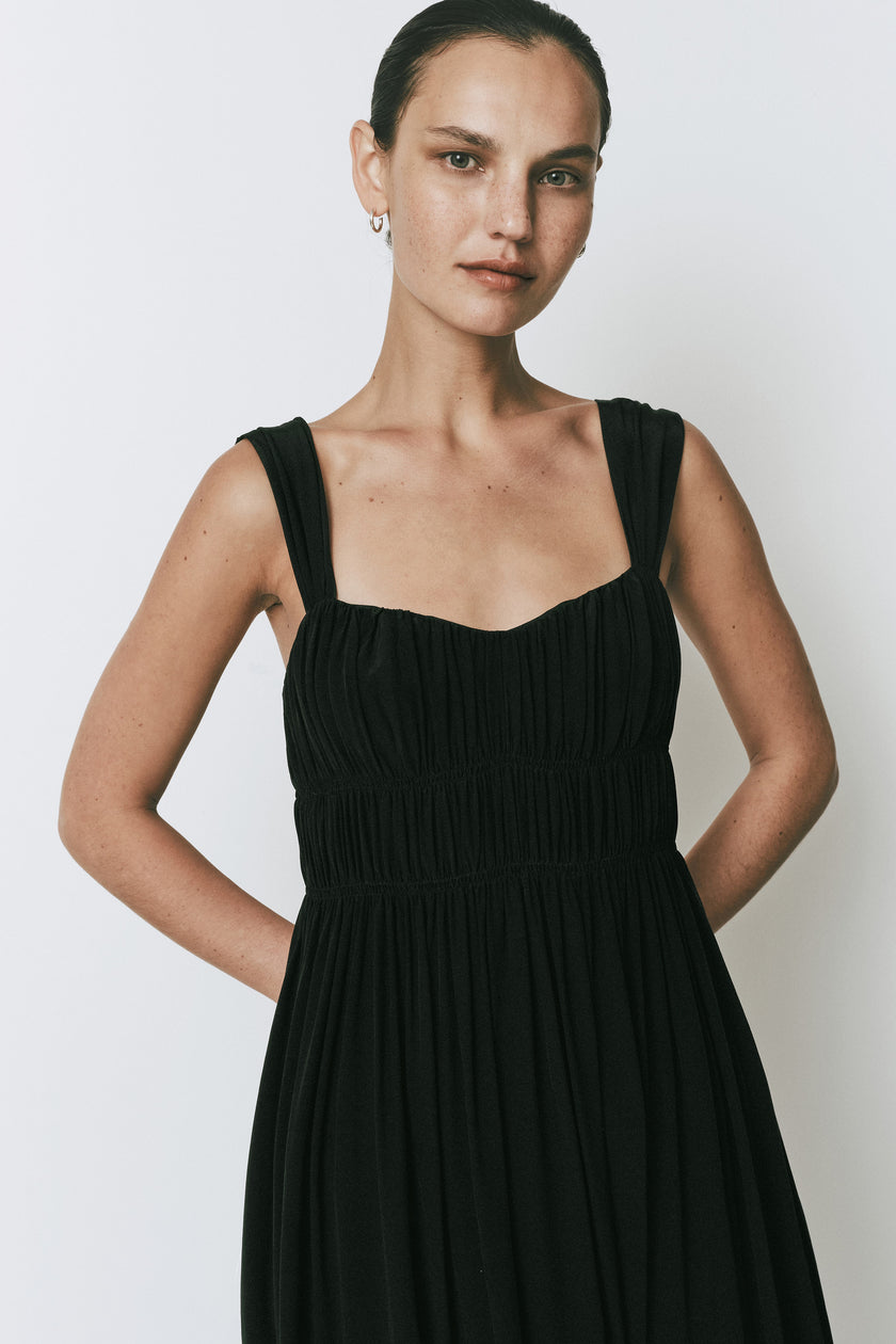 Black Coucou Dress by Rue Sophie, midi A-line with sweetheart neckline and wide straps.