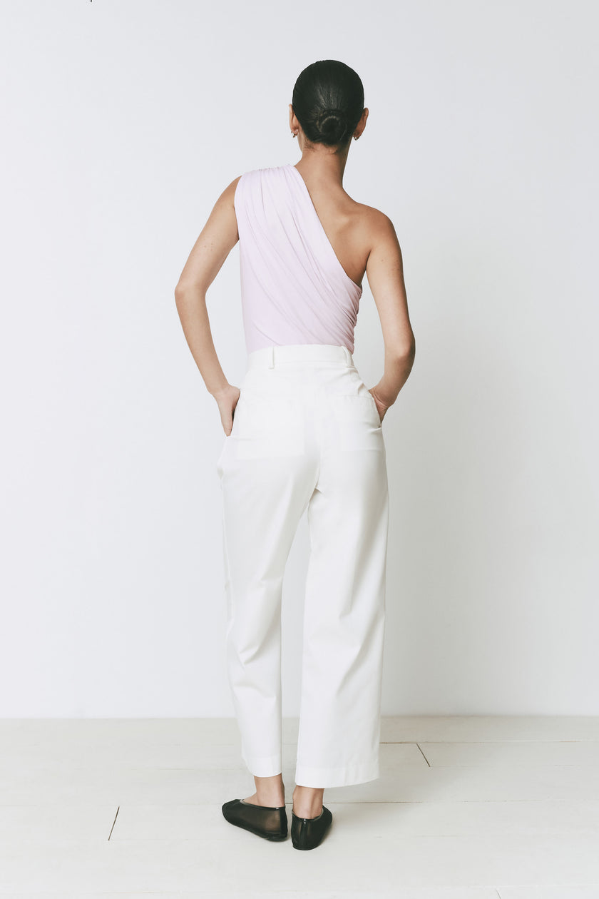 Perle Bodysuit with one-shoulder design in pink, paired with white trousers