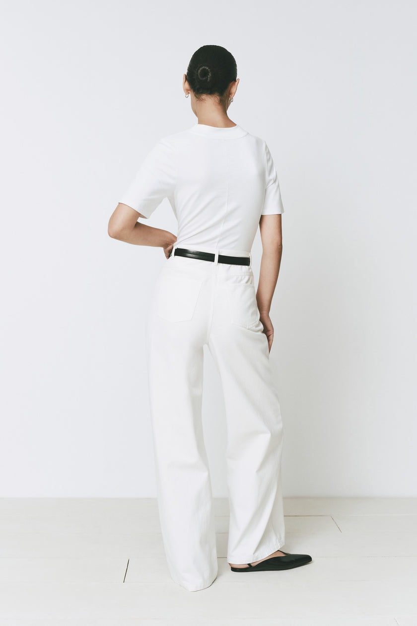 White Chabot Mock Neck Top with wide-leg pants, black belt and black shoes. Rue Sophie.