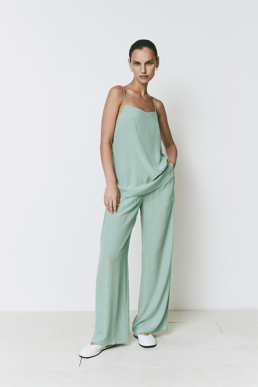 Mint green Esme top and relaxed pants set. Spaghetti strap top and wide-leg pants in a neutral palette.
