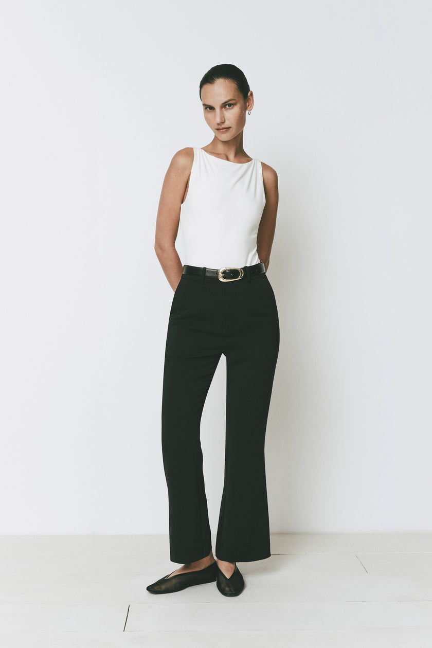 Ruesophie black Gesture Flare Pant on model, showing modern silhouette, clean lines, and subtle flare hem.