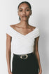 Louise Bodysuit: White wrap-style bodysuit with black pants and belt; sophisticated design for women