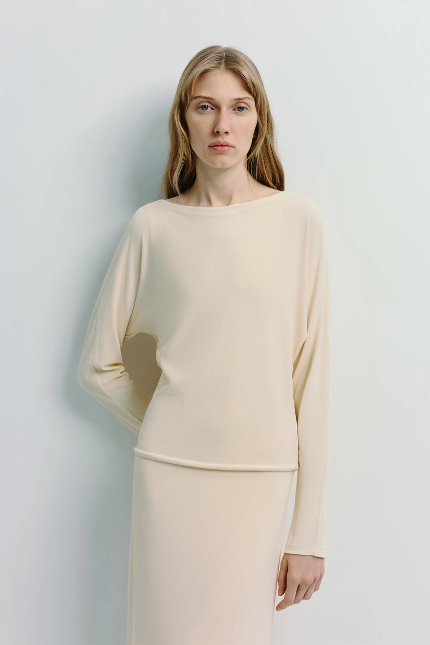 Cream Agla Dolman Sleeve Dress with dolman sleeves, midi length, relaxed fit, on model