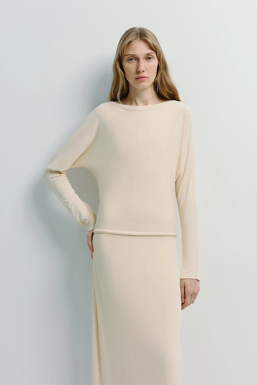 Cream Agla Dolman Sleeve Dress, midi length with dolman sleeves and relaxed fit, on a woman