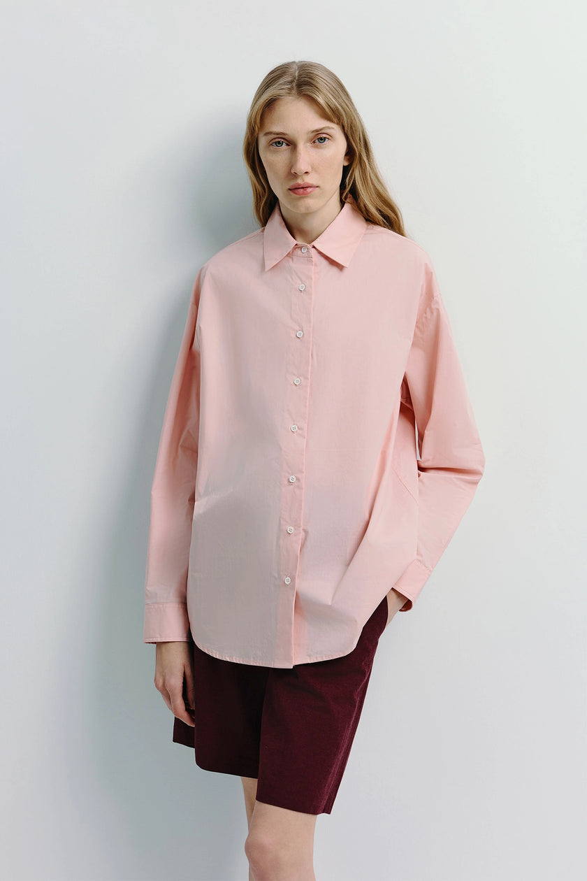 Light pink Alda Button Down Shirt on a model, relaxed fit, 100% cotton, perfect for layering.