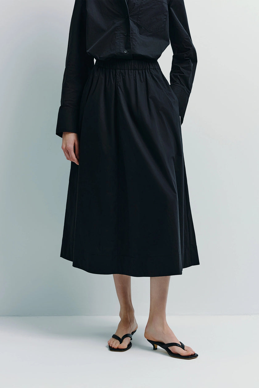 Andra Poplin Midi Skirt styled with black shirt, minimalist chic look, elastic waist skirt