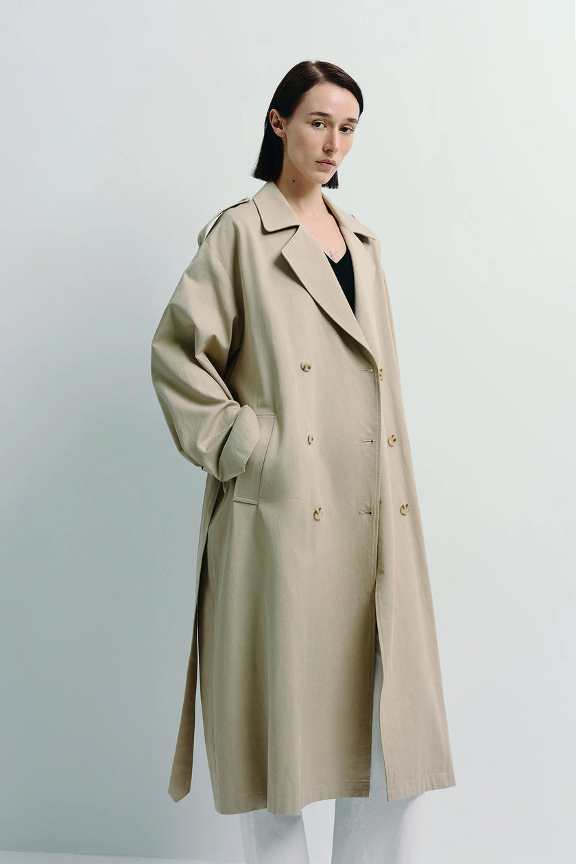 Beige Balham Trench Coat, double-breasted design, woman wearing neutral color coat
