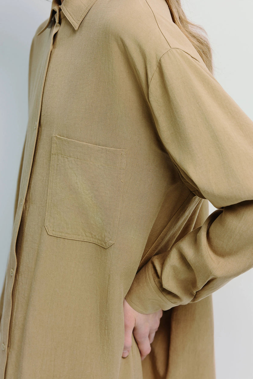 Tan Carel Oversized Shirt Dress in lyocell-linen blend, detail, showing pocket and sleeve.