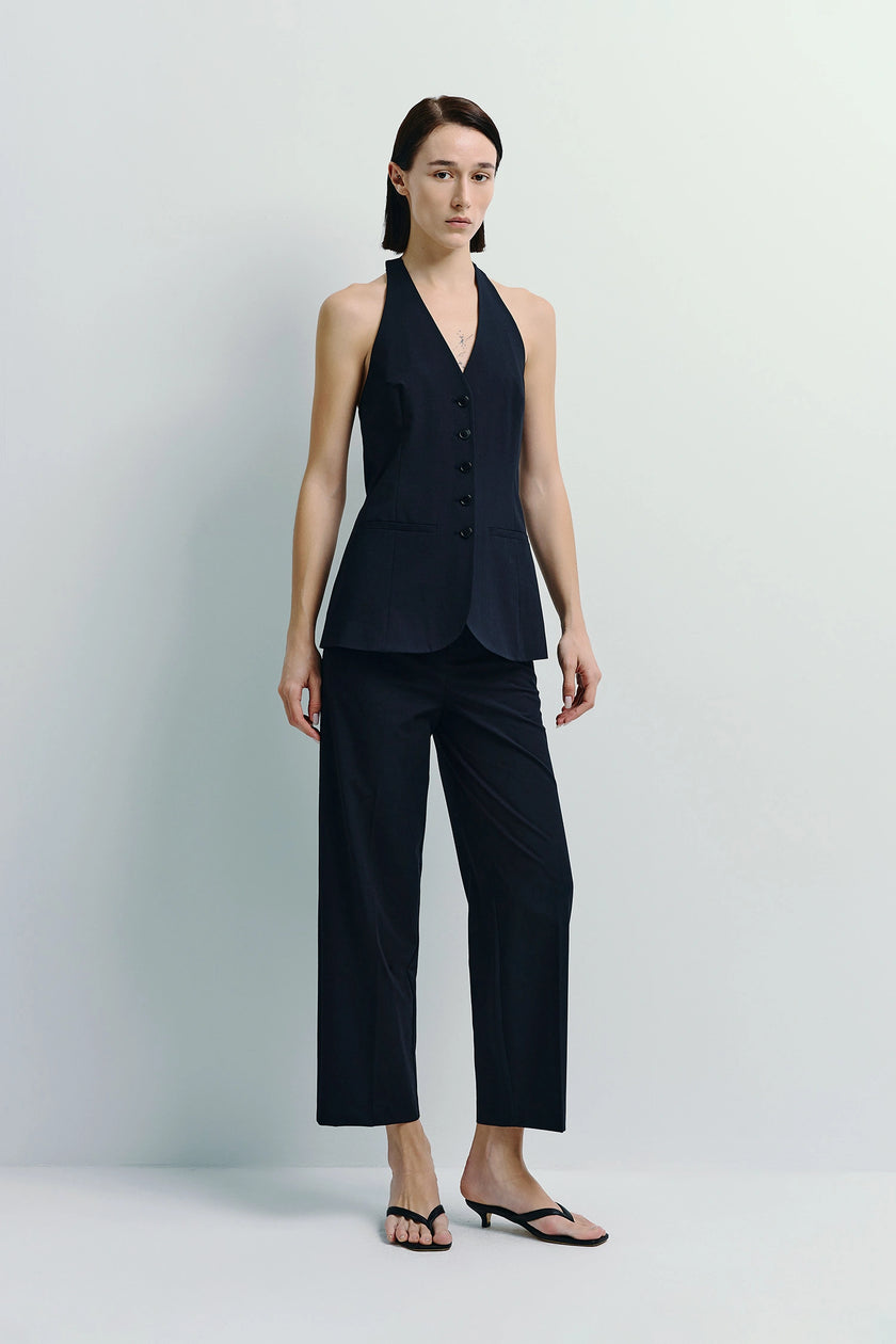 Donette halter vest and trousers in navy. A tailored modern ensemble featuring a button-front vest and wide-leg trousers.