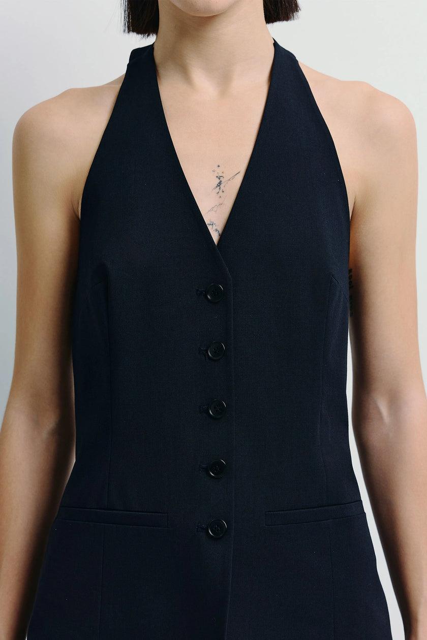 Donette Halter Vest in navy blue. Modern tailored halter vest featuring button-front detail.