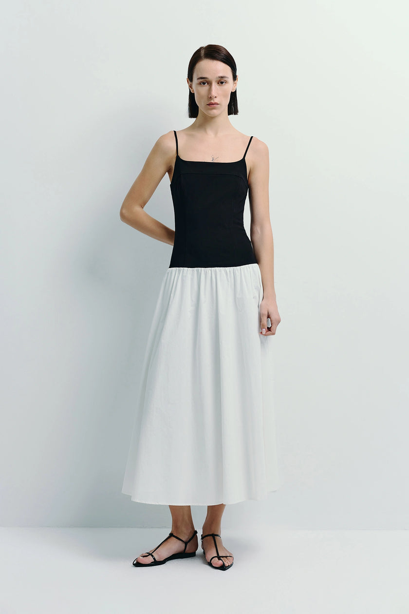 Ines Color Blocked Cami Dress in black top and white skirt, featuring spaghetti straps and a midi length.