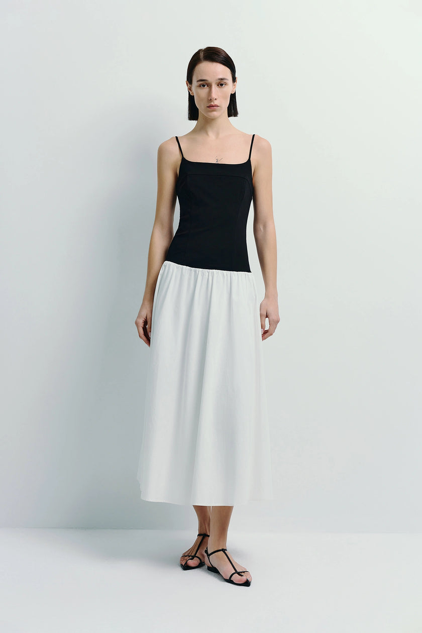 Ines Color Blocked Cami Dress in black top and white midi skirt, spaghetti strap details.