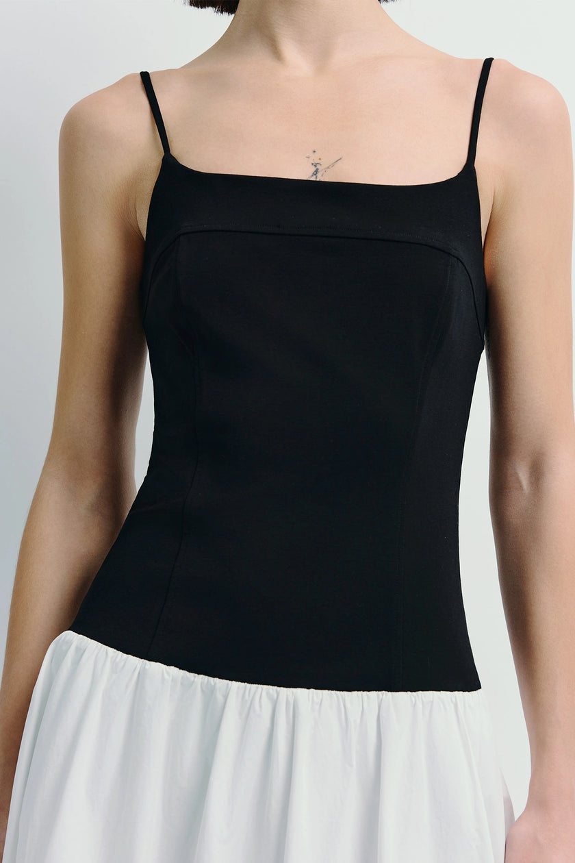 Ines Cami Dress in black top with white skirt. Featuring spaghetti straps and midi length.