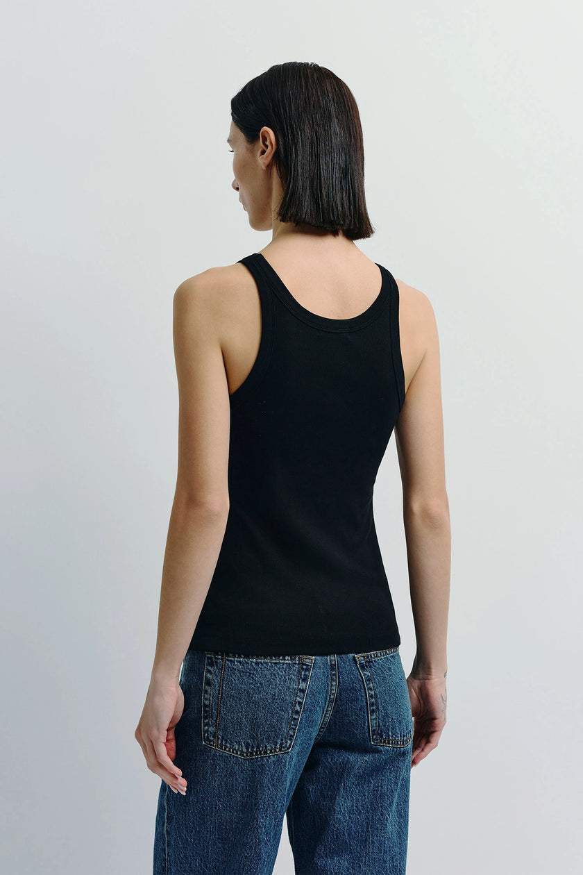 Black Luka Ribbed Tank Top and denim jeans. Cotton-viscose blend tank for women. Minimalist design.