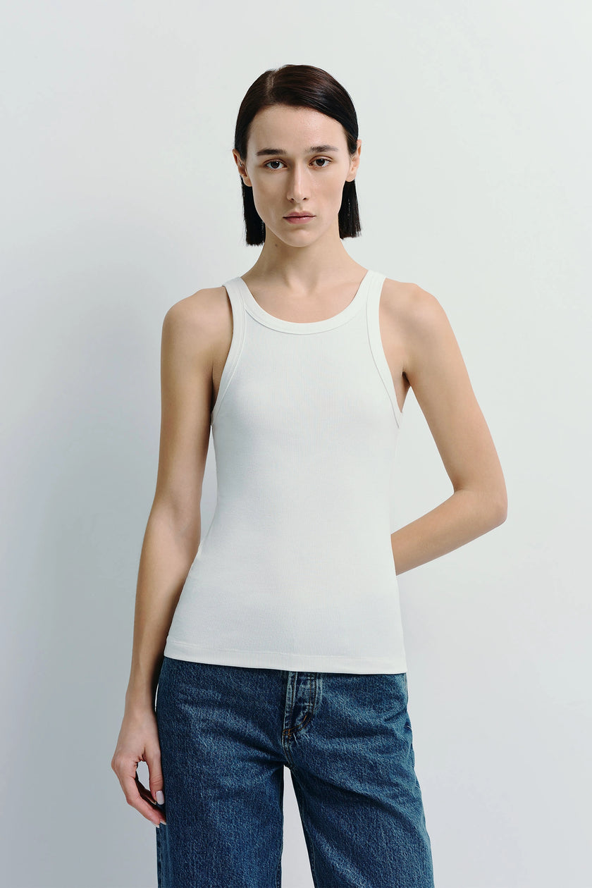 White Luka Ribbed Tank Top on a model, cotton-viscose blend, paired with denim jeans