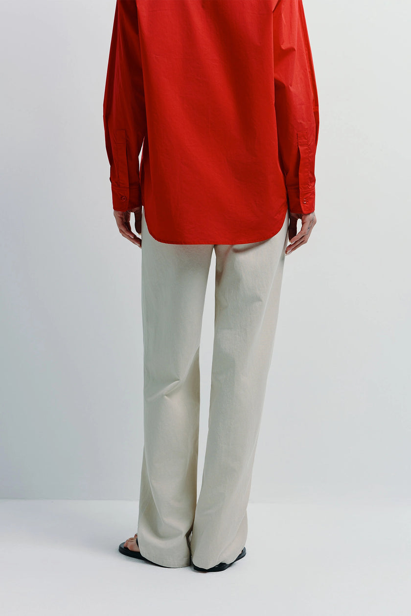 Cream Metis Straight Leg Pant with red shirt. Cotton-lyocell blend pants, relaxed fit for any wardrobe.