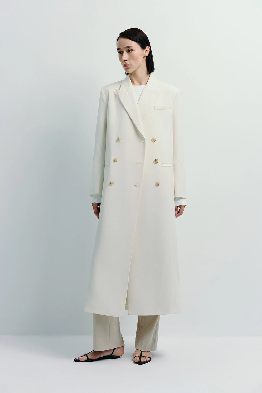 Remie Double Breast Coat in white. Sophisticated midi coat crafted from polyester-wool blend.