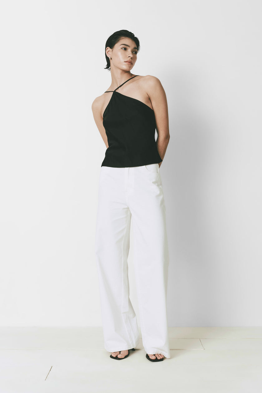 Black Yvoire top with halter neck and white wide leg pants