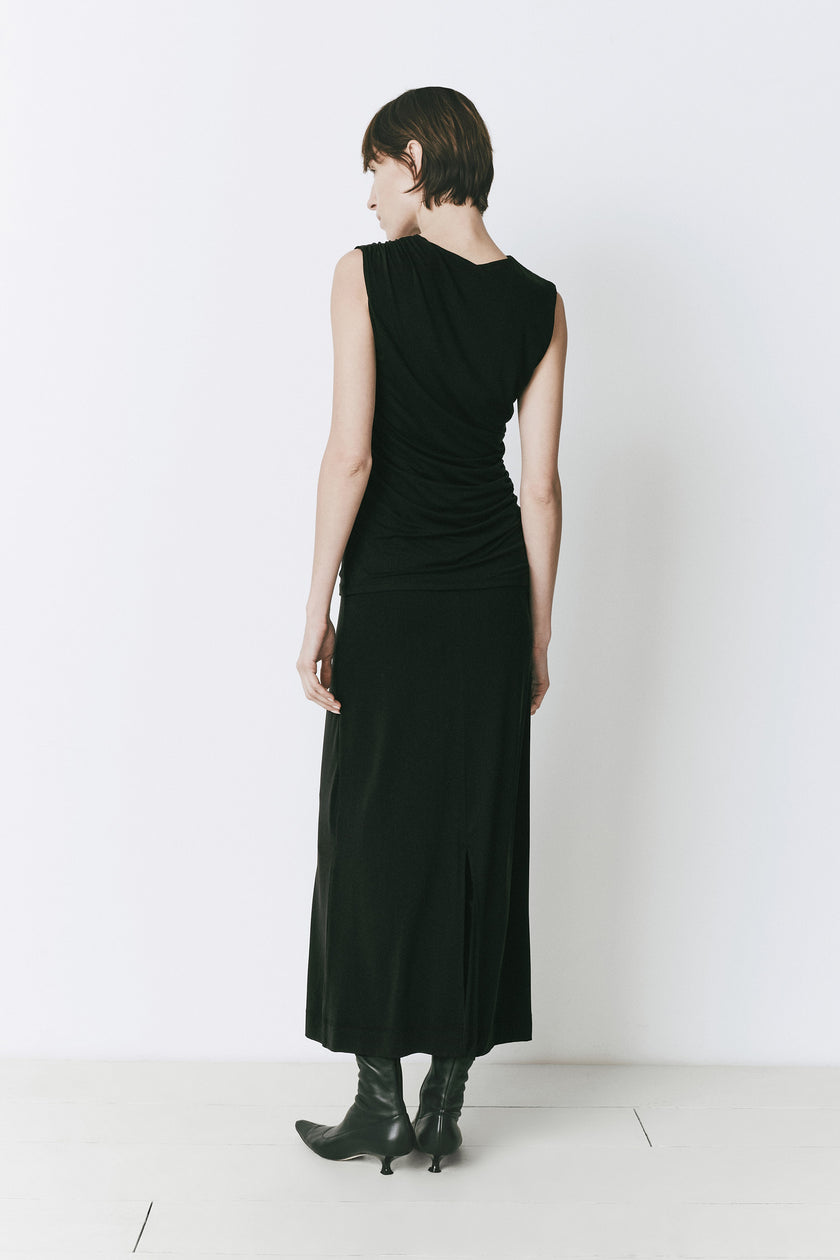 Black Alizé Modal Knit Top with side-ruched design and black skirt. Transitional dressing.