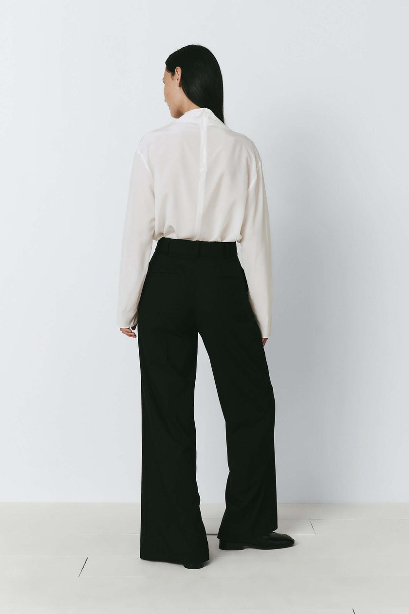 Allard collection: White silk mock neck top and black wide-leg pants
