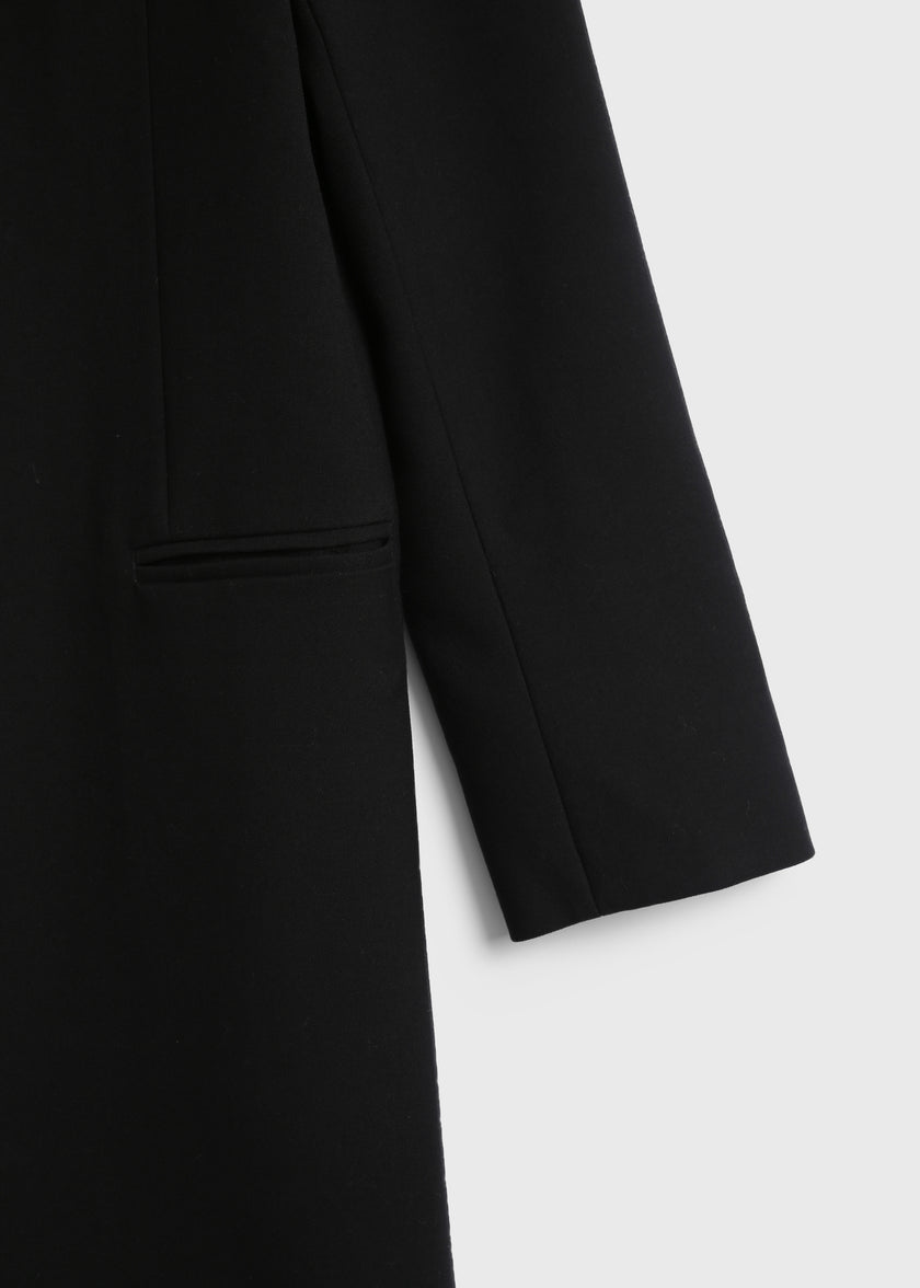 Augustin Deep Neck Coat in black wool-poly blend, featuring tailored sleeves and pocket details