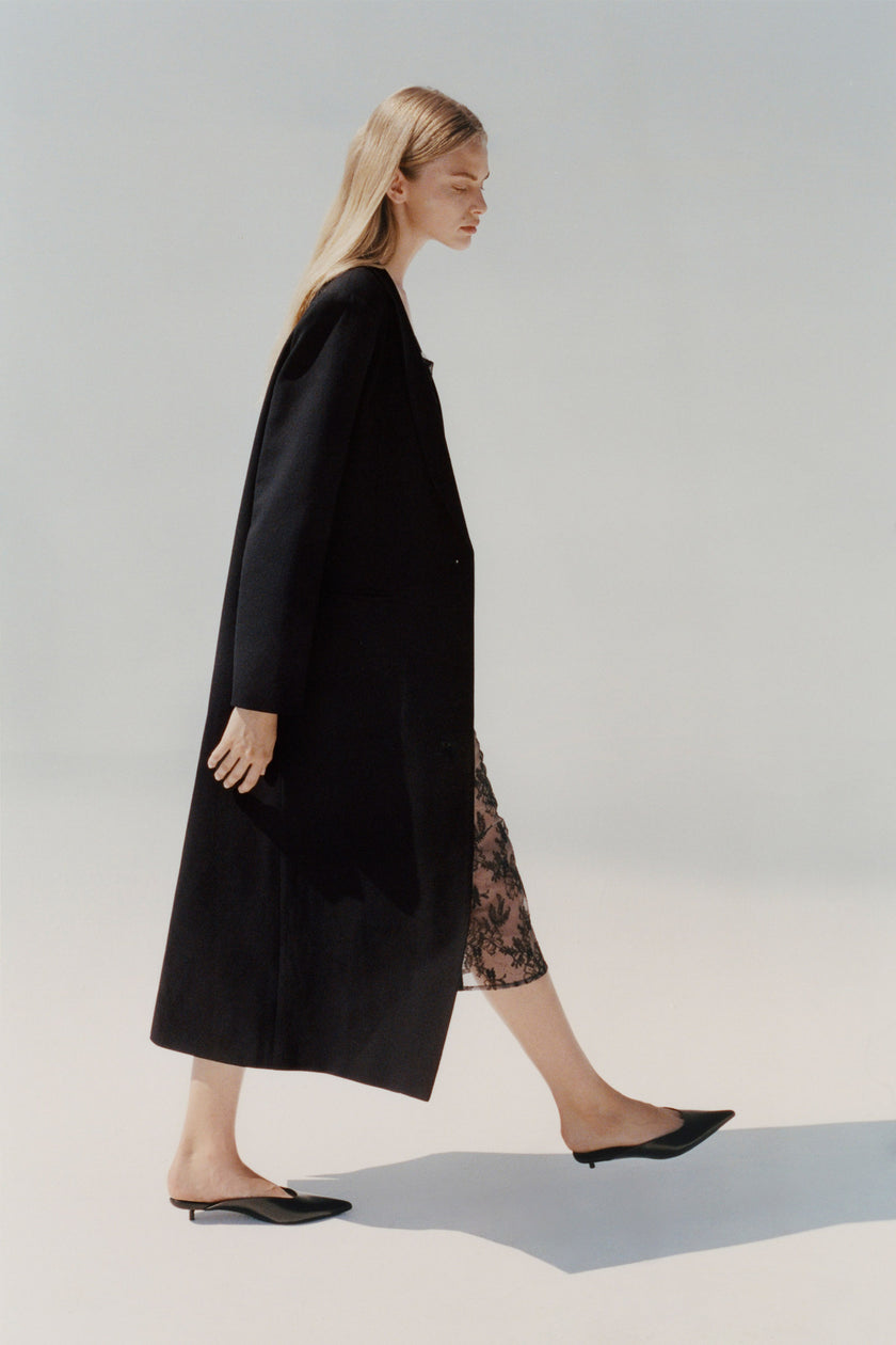 Black midi coat in wool blend, draped fit, styled with a lace dress and shoes, Rue Sophie