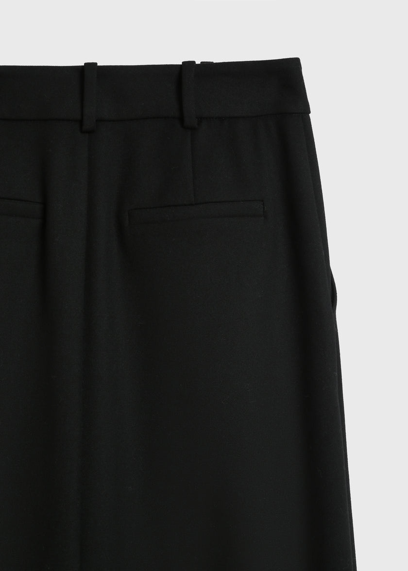 Close-up of black Belmont Wrap Skirt waistband and pocket detail, showcasing fabric and tailoring.