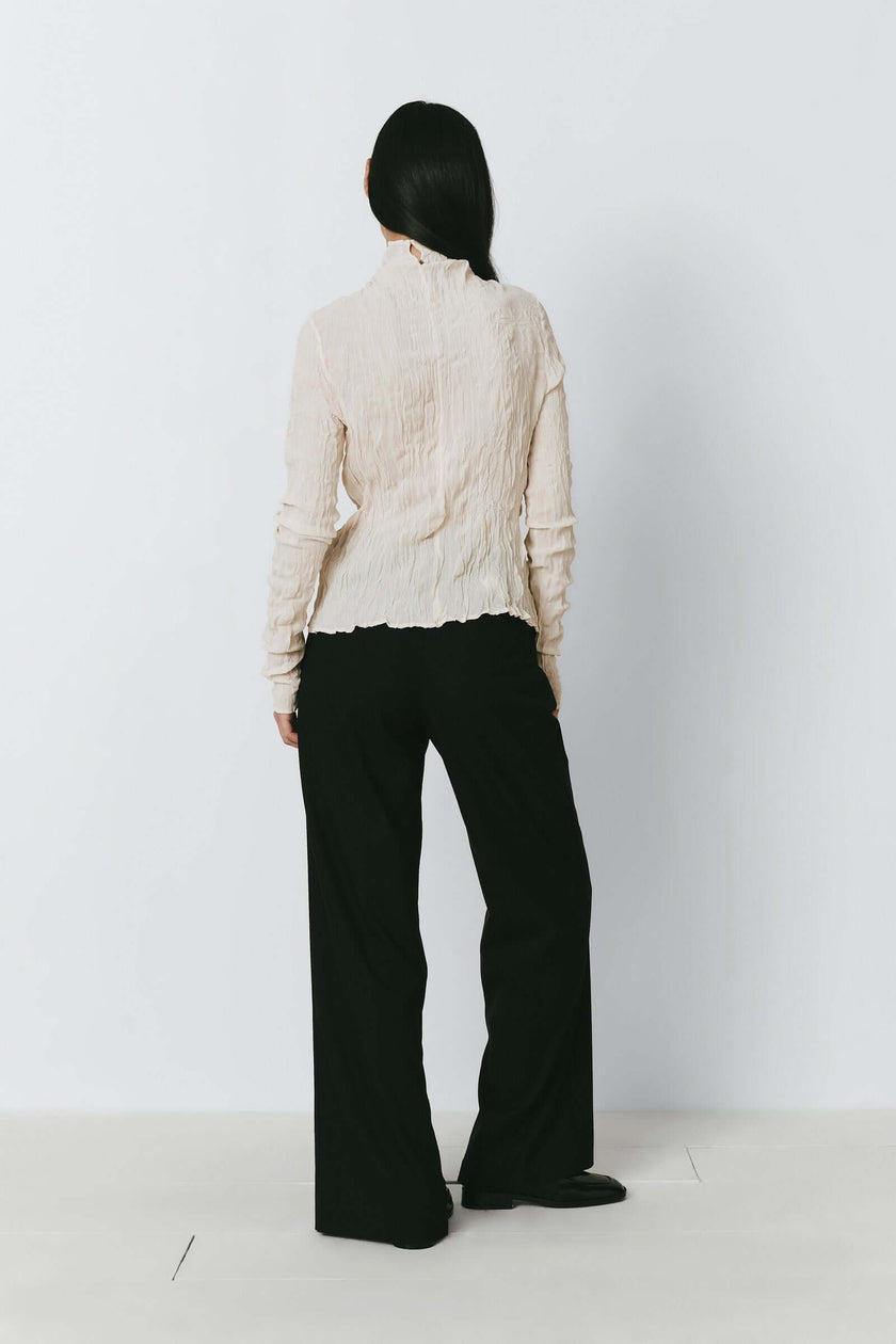 Ivory crinkled top and black trousers from Rue Sophie