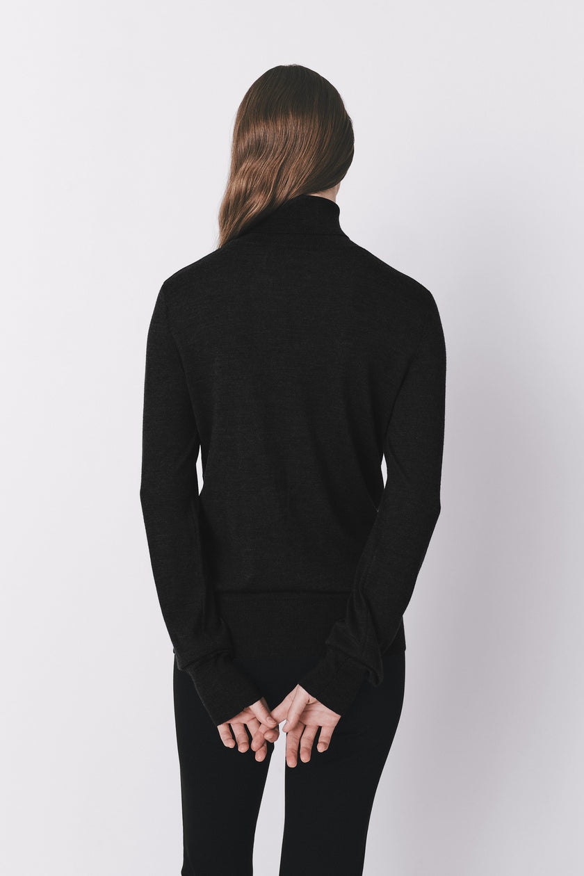 Black wool-silk turtleneck sweater on a model, minimalist design