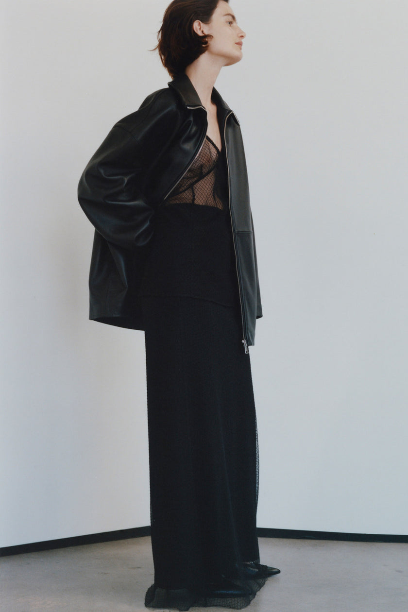 Black mesh skirt and leather jacket ensemble for layering or evening style