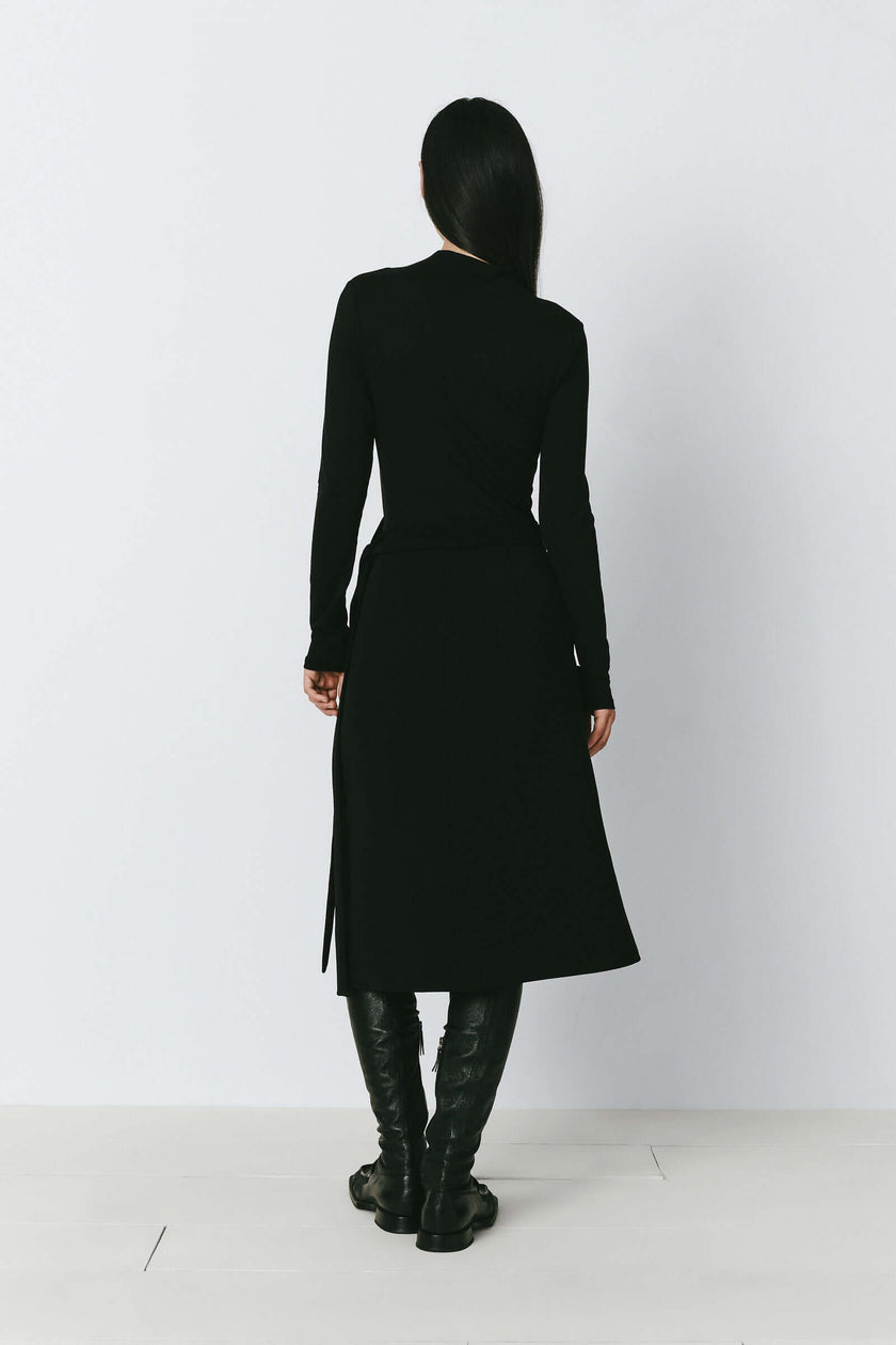 Black long-sleeved top and skirt with leather boots, minimalist design for fall outerwear by Ruesophie