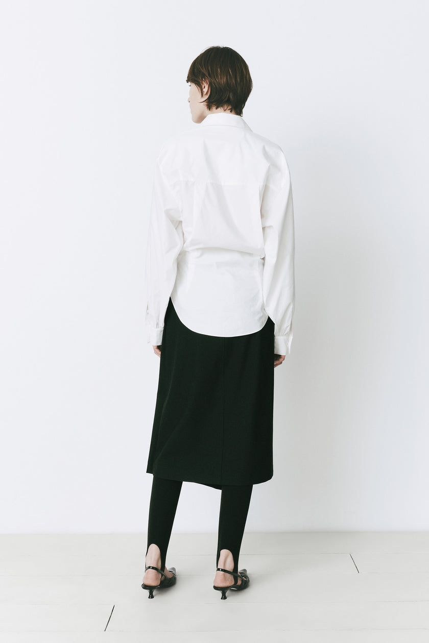 White cotton Fontaine balloon sleeve shirt with black skirt and leggings, sophisticated style