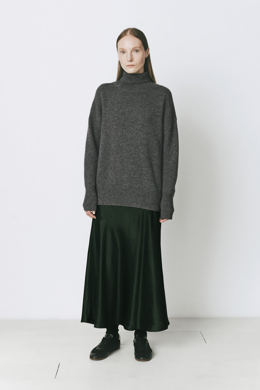 Garches oversized wool-cashmere turtleneck sweater with long dark green skirt, elegant winter wear