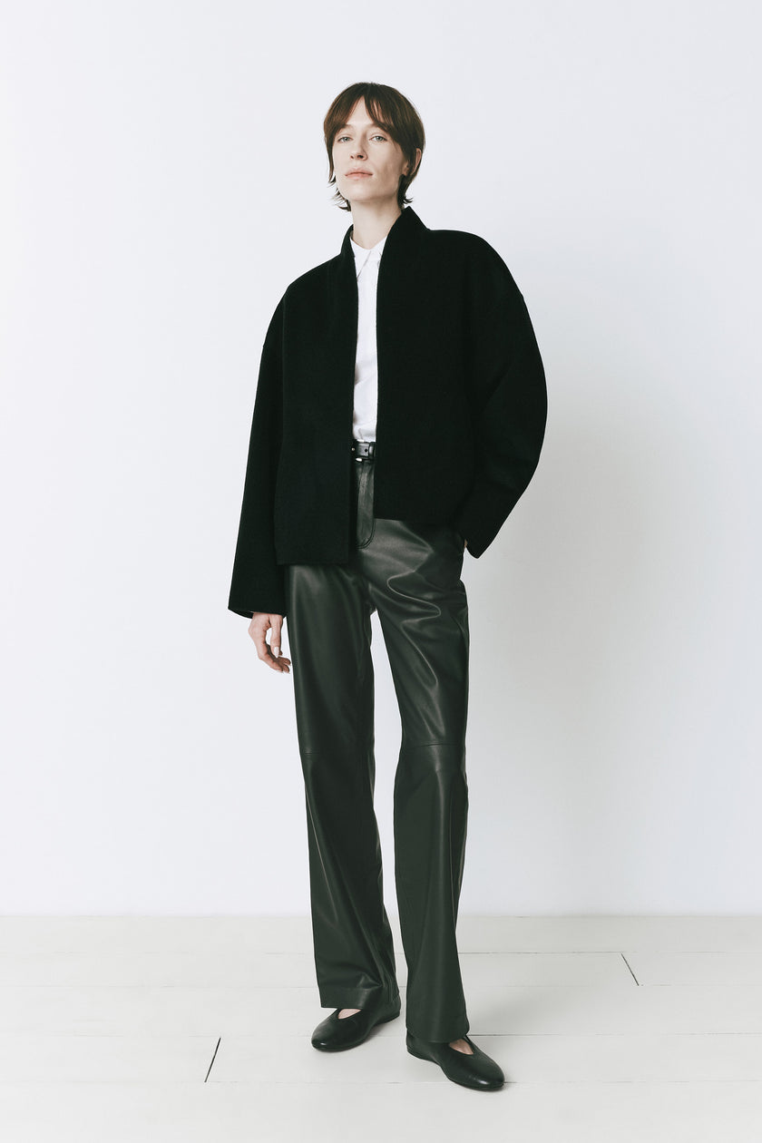 Jaurès Shawl Collar Jacket, a black wool-cashmere jacket with leather pants, perfect for fall layering and refined comfort.
