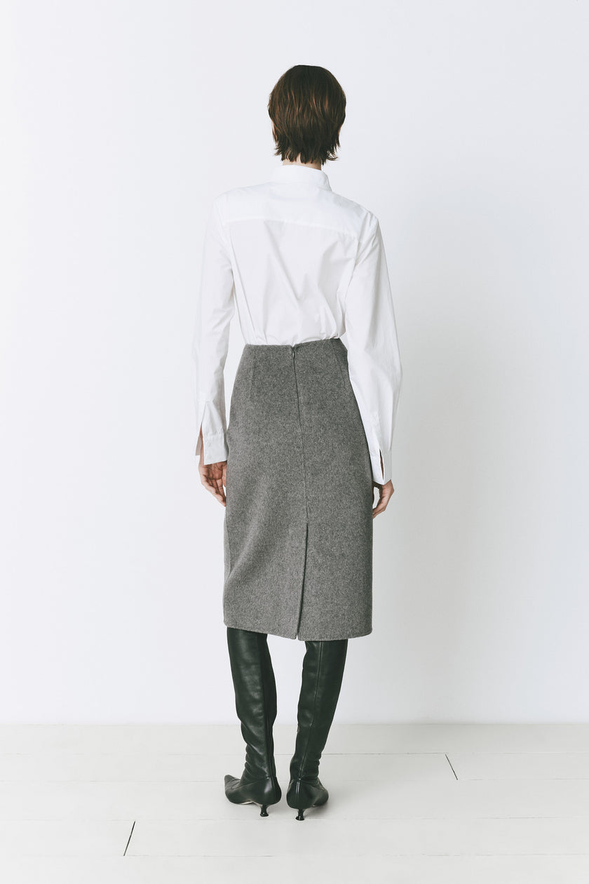 Ruesophie Le Marais gray wool-cashmere midi skirt, white shirt, and black boots. Sophisticated attire.