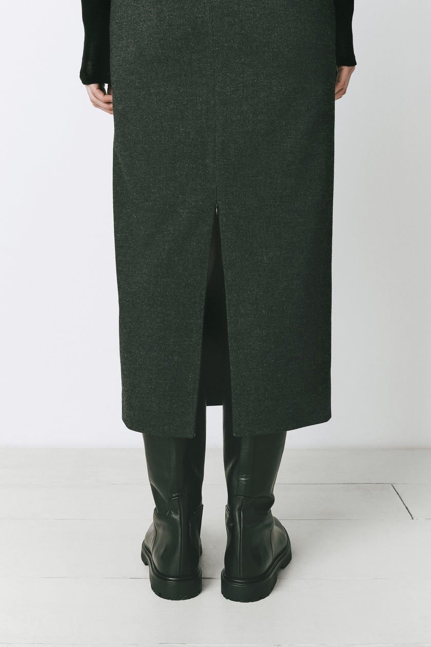 Dark green Léna Zip Slit Midi Skirt with back slit paired with black boots, wool blend skirt
