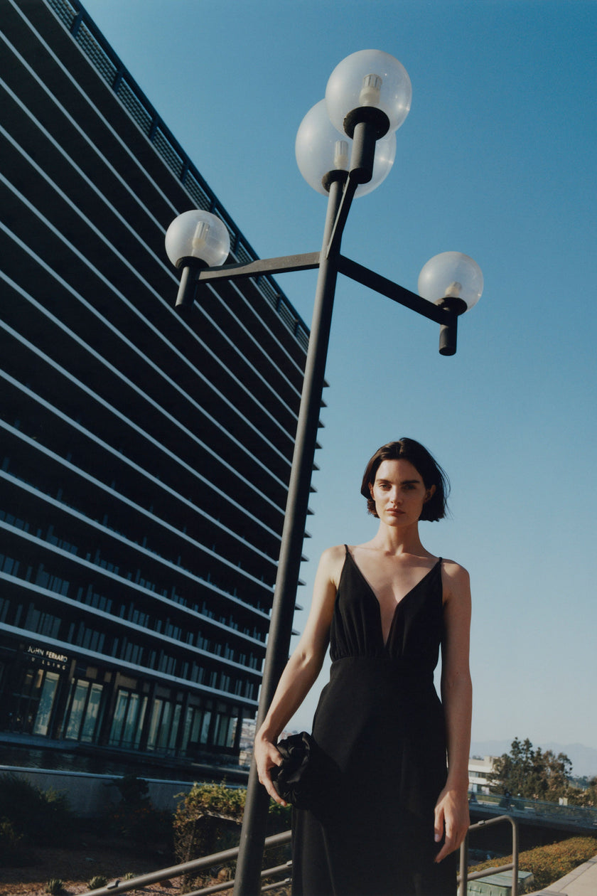 Black Liana Notch V-Neck Dress with deep V-neck, minimalist design, perfect for various occasions.