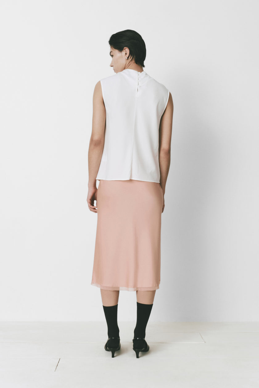 White Loire Top with high neck and a pink skirt, minimalist design
