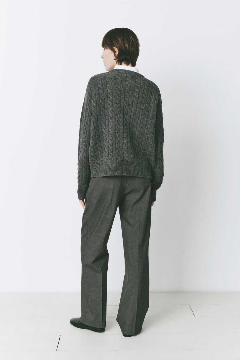 Cinder Lyon Cable Knit Sweater, wool-cashmere blend, paired with tailored gray trousers, perfect for fall.