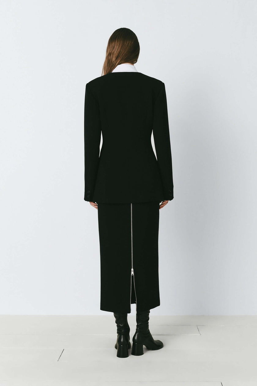 Black Marion Side Slit Jacket & Skirt Set, back view. Polyester-rayon blend with a side slit and zipper detail