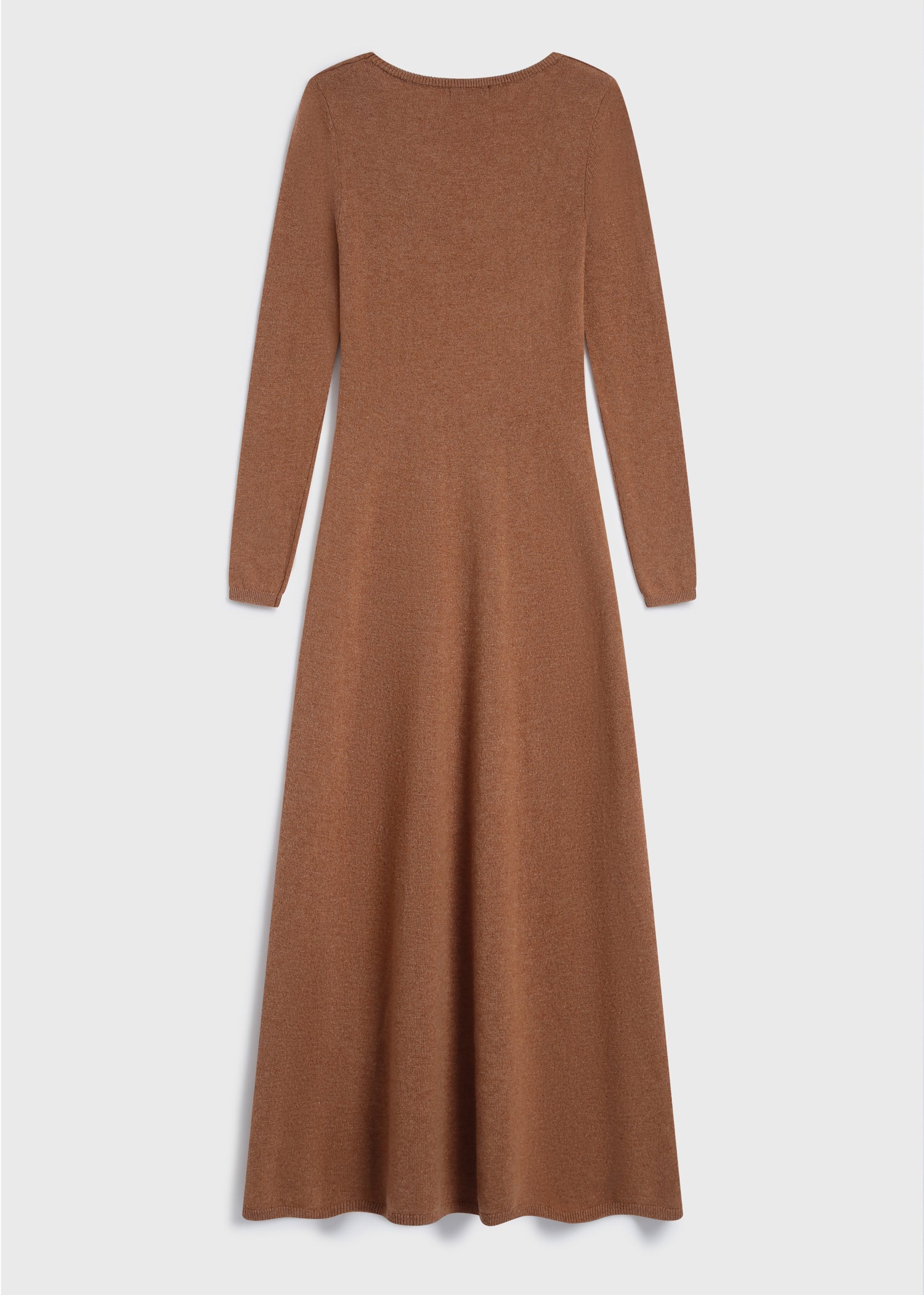 Model wearing the Mignet Sweater Dress, a long, oversized brown knit dress with a round neck and long sleeves