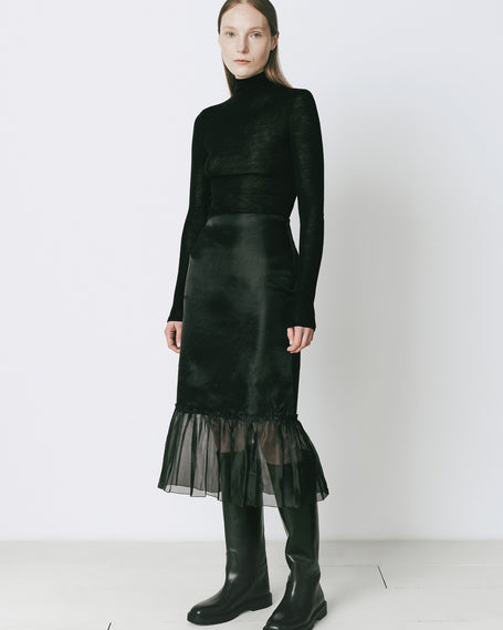 Black midi skirt with organza peplum hem and black boots, perfect for fall ensembles.