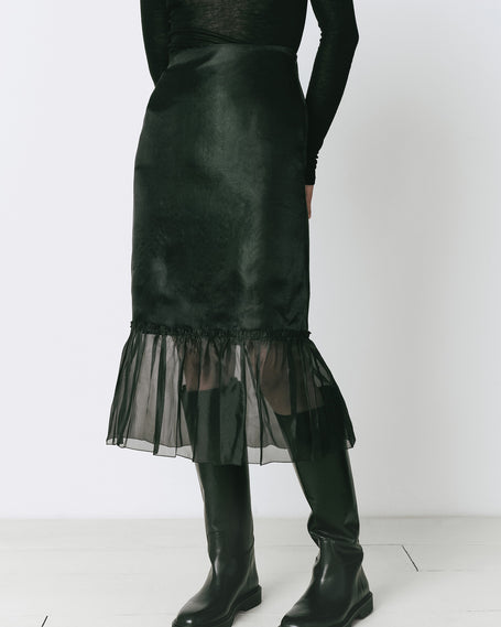 Black midi skirt with organza ruffle detail and black boots, perfect for fall ensembles